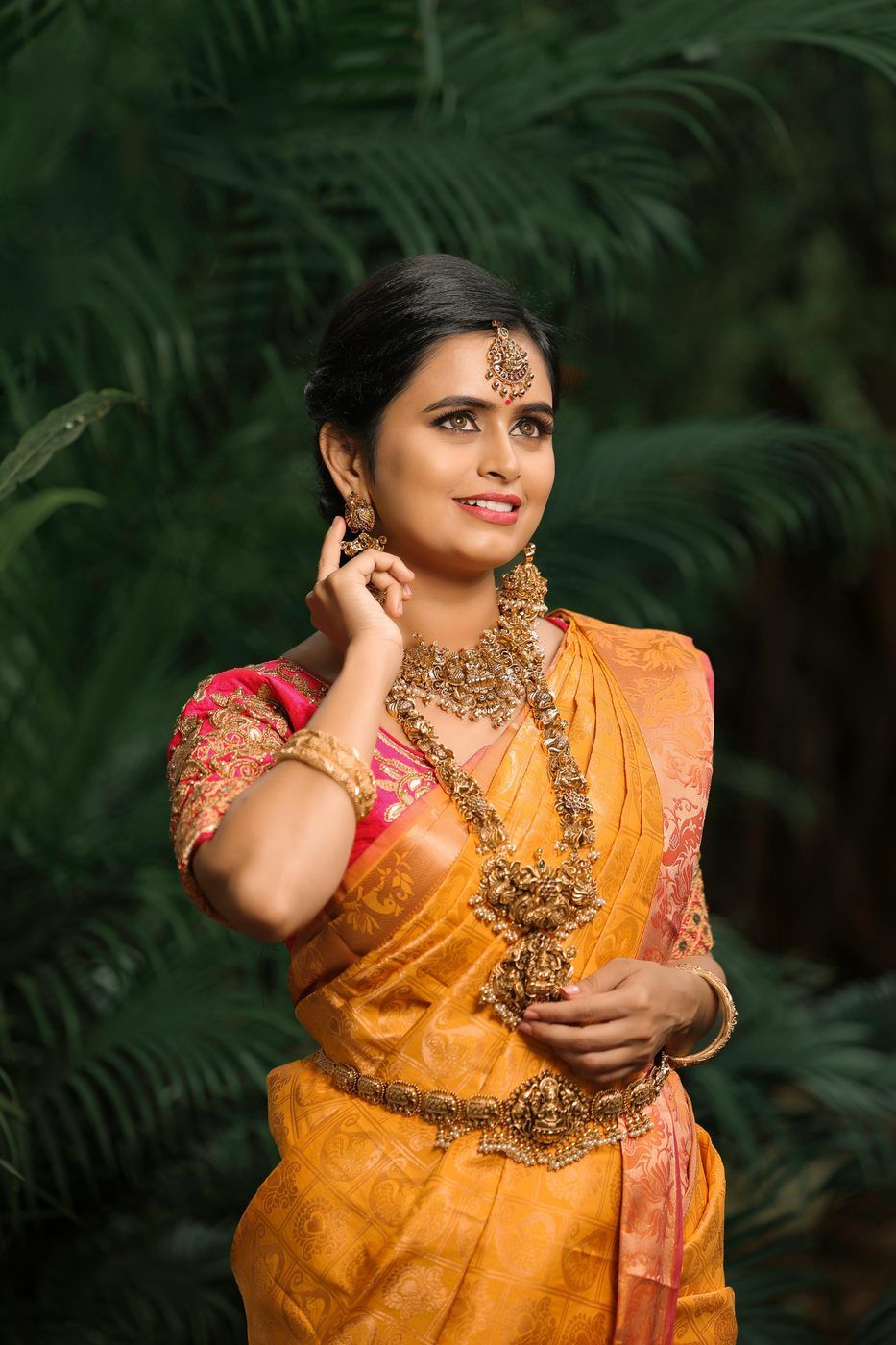 Model in a mustard Kanchipuram silk saree with temple jewellery